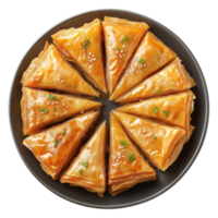 Traditional baklava pastry cut into triangular slices arranged in circle on dark plate, isolated on transparent background png