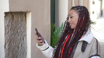 A Cheerful and Expressive Woman with Beautifully Braided Hair in a Vibrant Urban Setting video