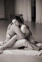 Couple practicing intimate hugging and emotional connection in a serene indoor space during a wellness retreat. photo