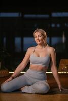 Yoga practice in a serene studio setting during twilight with a focus on flexibility and mindfulness photo