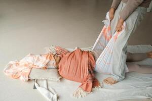 Wellness session in a serene studio focuses on relaxation techniques using a supportive wrap during a tranquil midday practice. photo