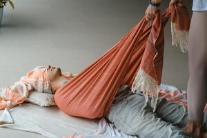 Yoga instructor prepares a class space with props and materials in a serene indoor studio environment during a morning session photo
