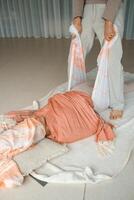 Wellness session in a serene studio focuses on relaxation techniques using a supportive wrap during a tranquil midday practice photo