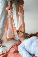 Wellness session with gentle stretching and relaxation practices in a serene indoor setting during daylight hours. photo