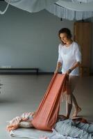 Yoga instructor prepares a class space with props and materials in a serene indoor studio environment during a morning session. photo