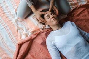 Relaxation and healing through gentle massage in a serene indoor setting during a wellness session photo