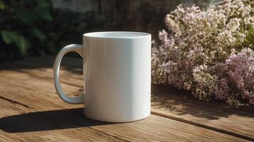 White coffee mug sits on a wooden table next to a bouquet of flowers photo