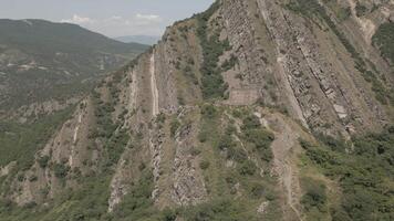 Drone footage reveals sharply folded rocky terrain and exposed ridgeline, showcasing raw geological patterns and wild highland environment video