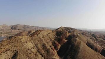 Aerial rainbow or red mountains, colorful layers of the Rainbow Mountains in Georgia,Caucasus region. The striking mineral patterns, rolling hills form surreal, painterly landscape from above video