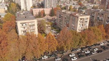 Drone footage of busy city street during fall, cars in traffic jam, concept of urban density, mobility, environment, daily routine in modern infrastructure video