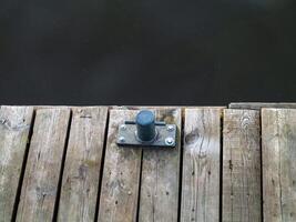Metal object is sitting on a wooden dock. Zagrze lake, Poland photo