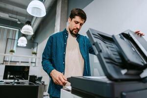 Office worker using a printer in a modern workspace during the afternoon photo