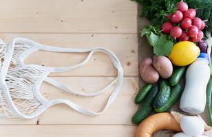 Classic cold soup ingredients for okroshka displayed in a vibrant top-down kitchen scene. photo