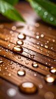 Close-up of Raindrops on Wooden Surface With Green Leaves in Background During a Tranquil Morning photo
