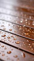 Raindrops Glisten on Wooden Deck Planks in a Peaceful Outdoor Setting After a Refreshing Rainfall photo