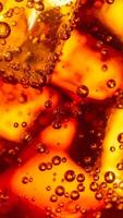 Bubbles Rising in a Fizzy Beverage Showcasing Vibrant Orange Hues in a Close-Up View photo