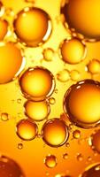 Bubbles of Golden Liquid Capture Light and Texture in an Abstract Composition Set Against a Warm Background photo