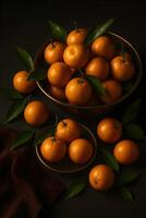 Fresh mandarin orange with green leaves on dark background photo