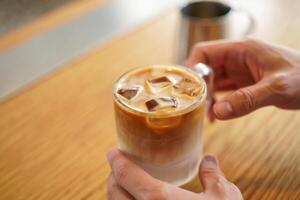 Coffee Background Refreshing Iced Latte Coffee Drink in Glass Close Up View photo