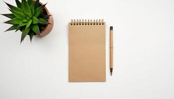 Flat lay of open notebook with pencil and greenery in modern natural style. photo