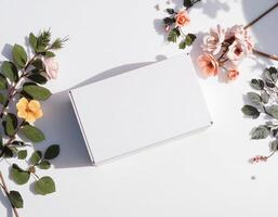 An empty white box with flowers on a white surface photo