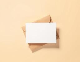Blank white envelope with a note on a beige background photo
