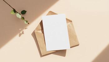 Blank card on envelope with leaves on light background photo