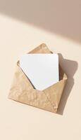 An envelope with a blank card inside on a light background photo