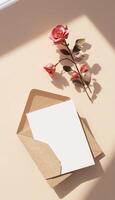 An envelope with a rose and a note on a table photo