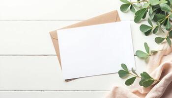 Blank card and eucalyptus leaves on white wooden background photo