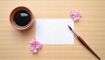 A note with a cup of tea and a brush on a wooden table photo
