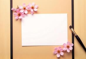 A blank sheet of paper and a brush on a wooden background photo