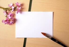A note and a paintbrush on a wooden table photo