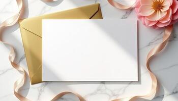 An envelope with a blank card and a flower on a marble surface photo