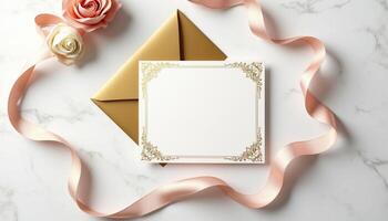 An envelope with a gold ribbon and rose on a marble surface photo