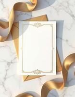 Golden envelope with a blank paper and gold ribbon on marble background photo