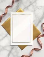 Golden envelope with a blank white paper on marble background photo