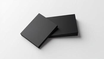 Two black square boxes on a white surface photo