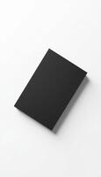 A black sheet of paper on a white surface photo