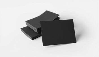 A stack of black paper on a white surface photo