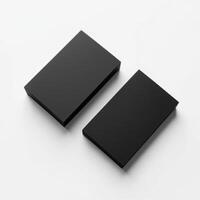Two black boxes on a white surface photo