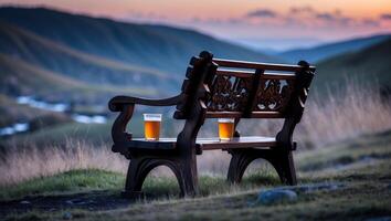 Bench with Beverages Overlooking Mountain Landscape at Sunset, Relaxing View photo