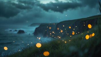 Glowing Lights on Grassy Cliff Overlooking Ocean Water at Night photo