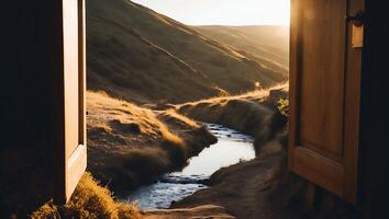 Open Doorway Overlooking River Flowing Through Golden Hills Landscape photo