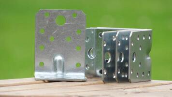 Metal brackets on wooden surface under natural lighting suitable for construction and assembly projects photo
