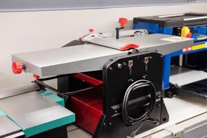 Woodworking machine for precise cuts in a workshop environment located indoors during daylight hours photo