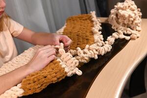 Creative project in a cozy indoor setting, showcasing a person working on a handmade textile piece using modern techniques photo