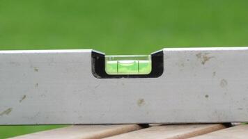 Using a level tool to ensure precision in construction and renovation tasks outdoors photo
