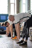 Determined rowers prepare for gym, stretching muscles, bending forward, activating flexibility photo