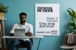 Man Working at a Desk with a Poster Mockup psd